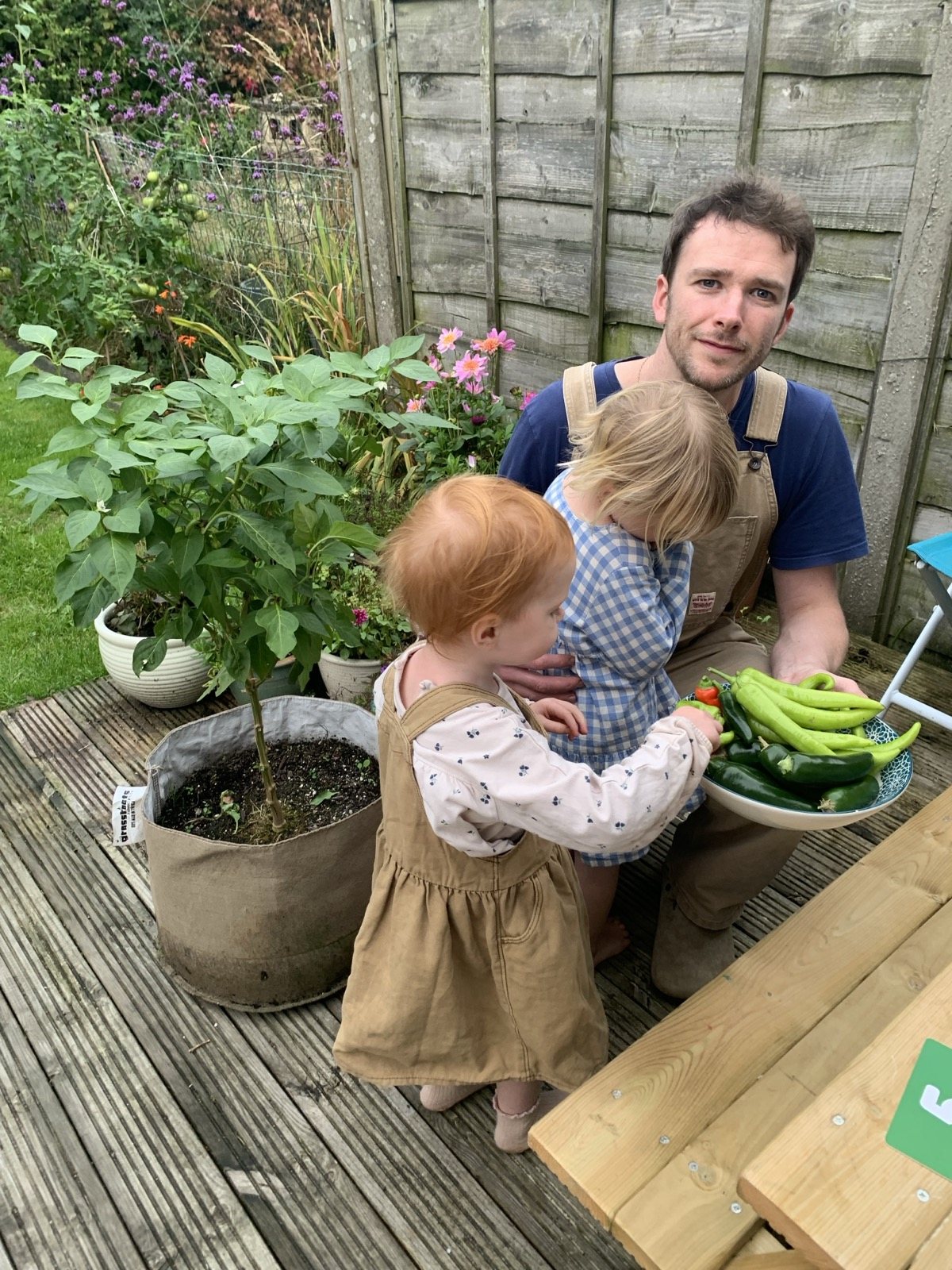 Joe Barrington, founder of Dr Forest, in his garden with a bowl of home-grown chillies and peppers