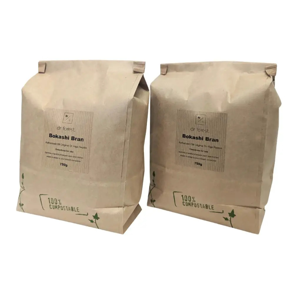 Organic Bokashi Bran — two 750g beige paper bags side by side, 100% Compostable mark with ivy graphic