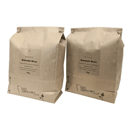 Organic Bokashi Bran — two 750g beige paper bags side by side, 100% Compostable mark with ivy graphic