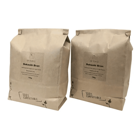 Organic Bokashi Bran — two 750g beige paper bags side by side, 100% Compostable mark with ivy graphic