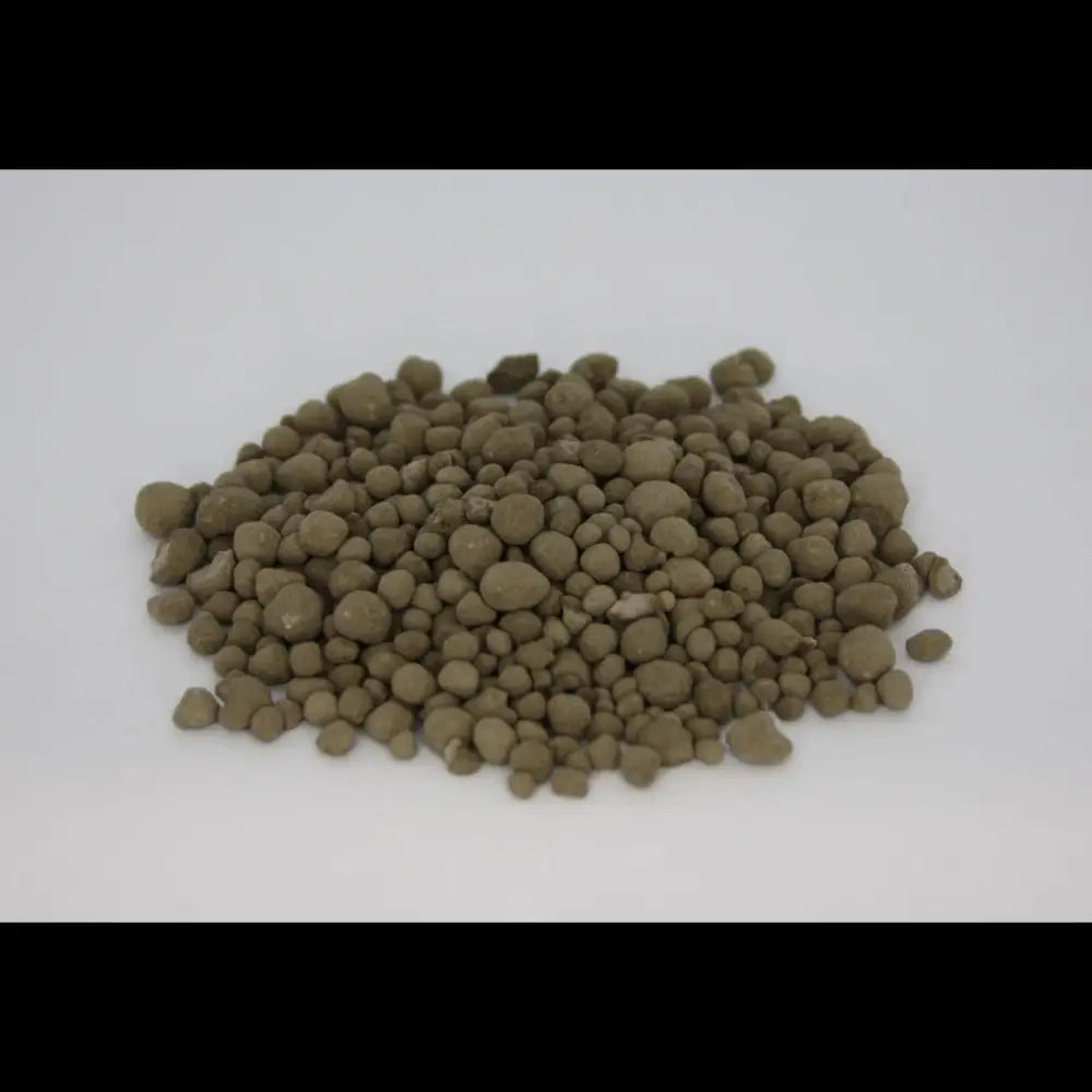 Granulated Volcanic Rock Dust — pile of olive-brown round mineral granules