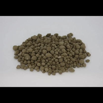 Granulated Volcanic Rock Dust — pile of olive-brown round mineral granules