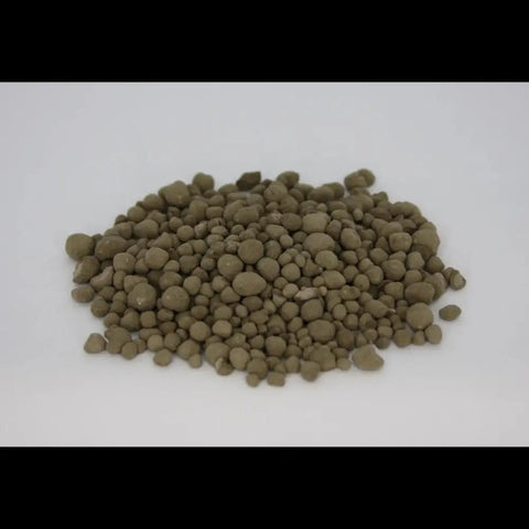 Granulated Volcanic Rock Dust — pile of olive-brown round mineral granules