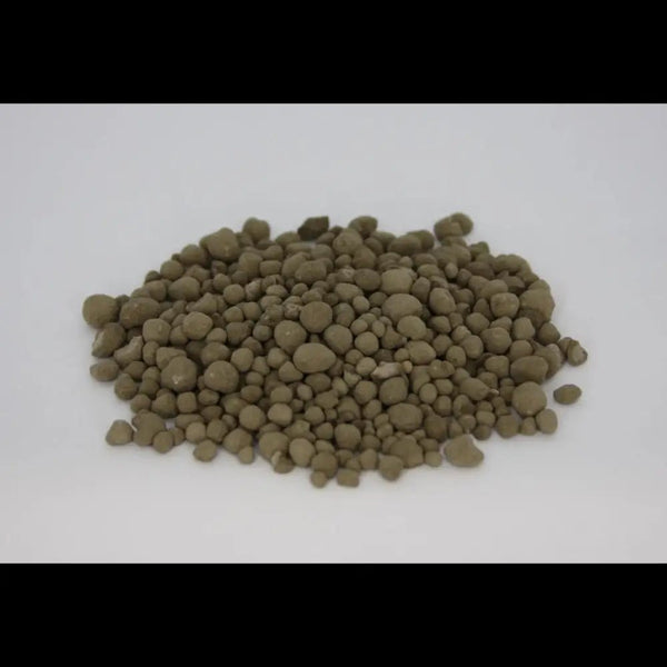 Granulated Volcanic Rock Dust — pile of olive-brown round mineral granules