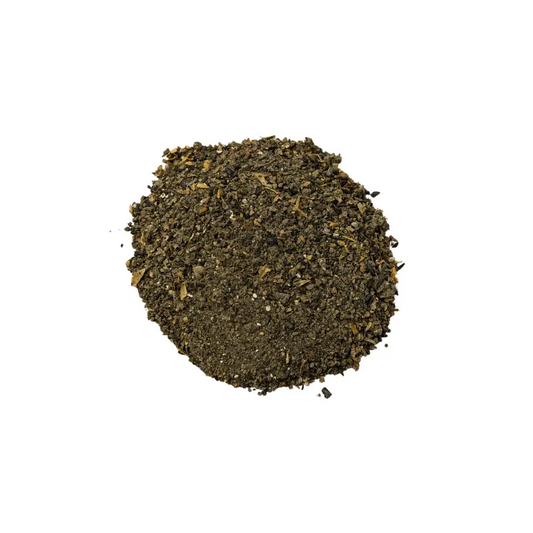 Premium Living Soil Fertiliser — pile of dark green-brown granular blend with visible flakes and grit